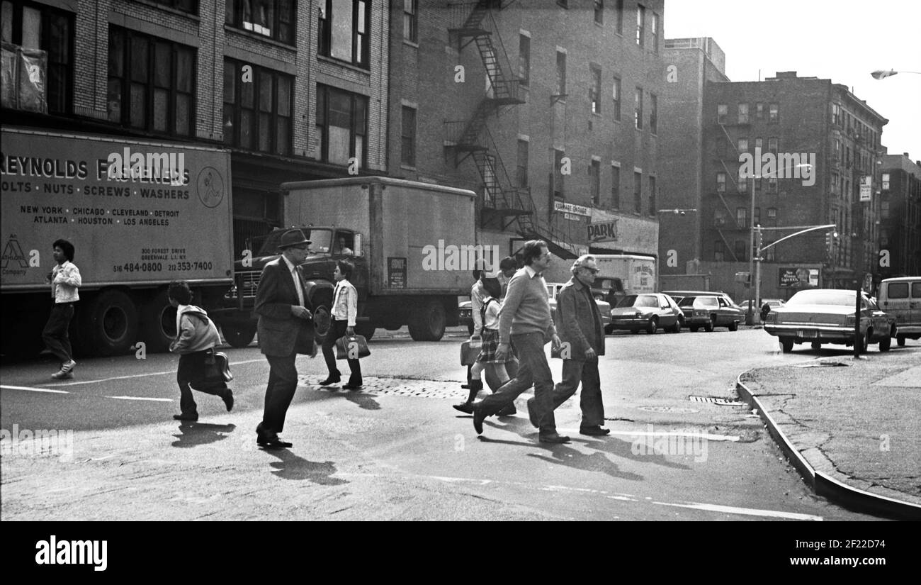 Pedestrians cross the street. New York, USA, 1977 Stock Photo