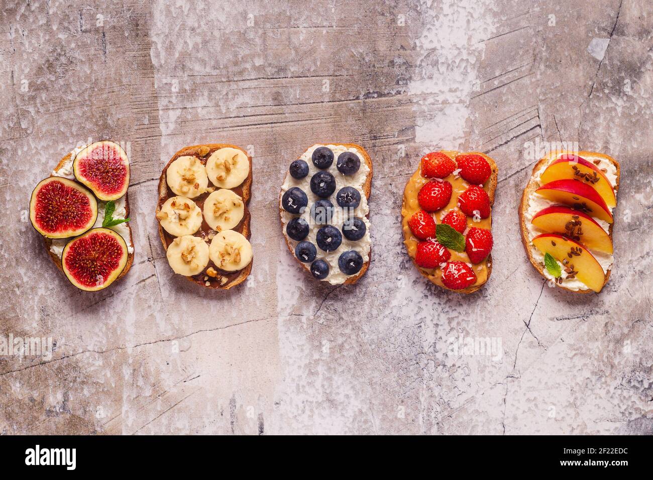 Homemade summer toast with cream cheese, nut butter and fruits and