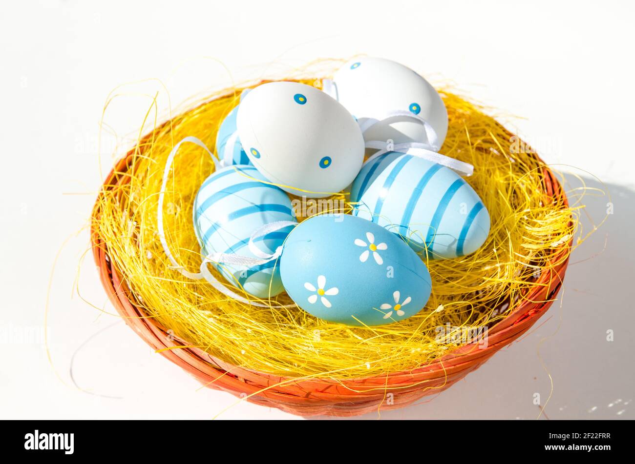 blue white easter eggs in basket isolated Stock Photo - Alamy