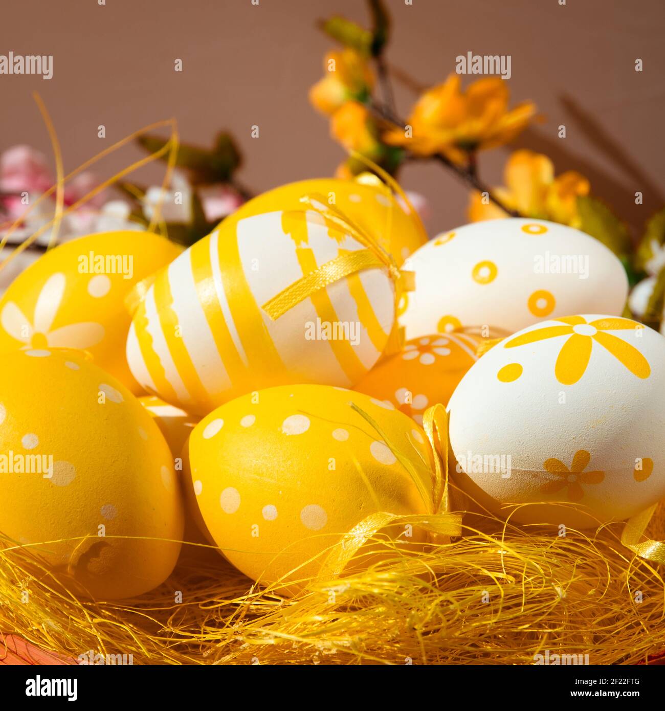 orange easter eggs over yellow straw Stock Photo