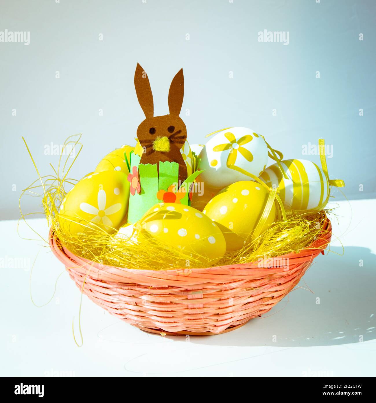 yellow easter eggs over yellow straw in the basket Stock Photo