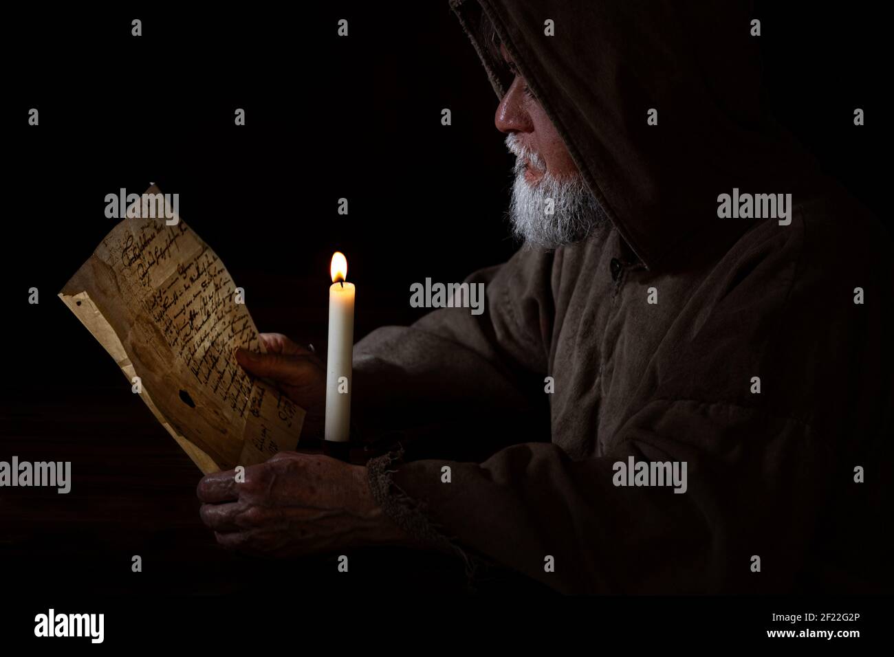 Medieval monk reads and thinks Stock Photo