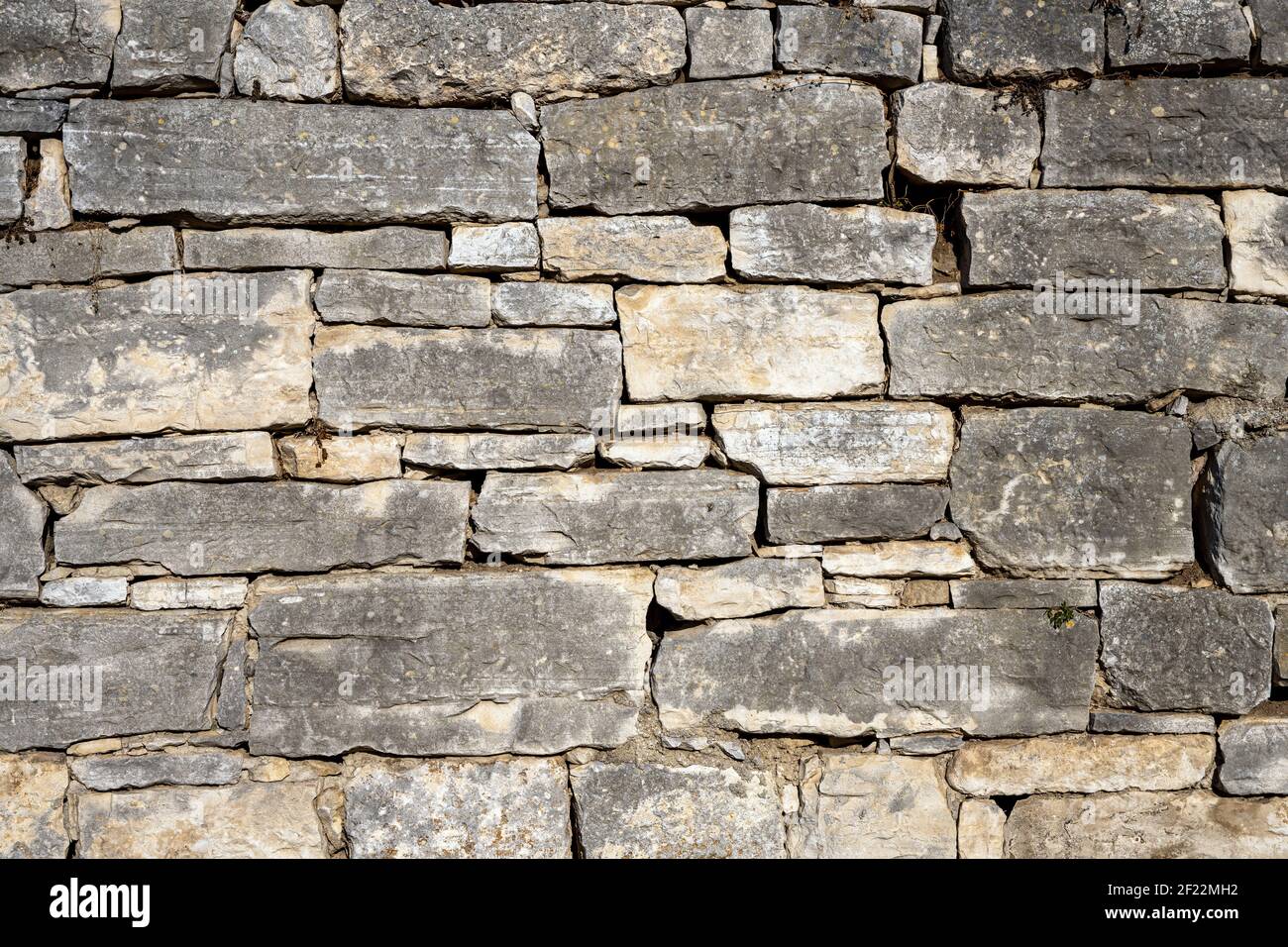Background from an old and worn natural stone wall Stock Photo