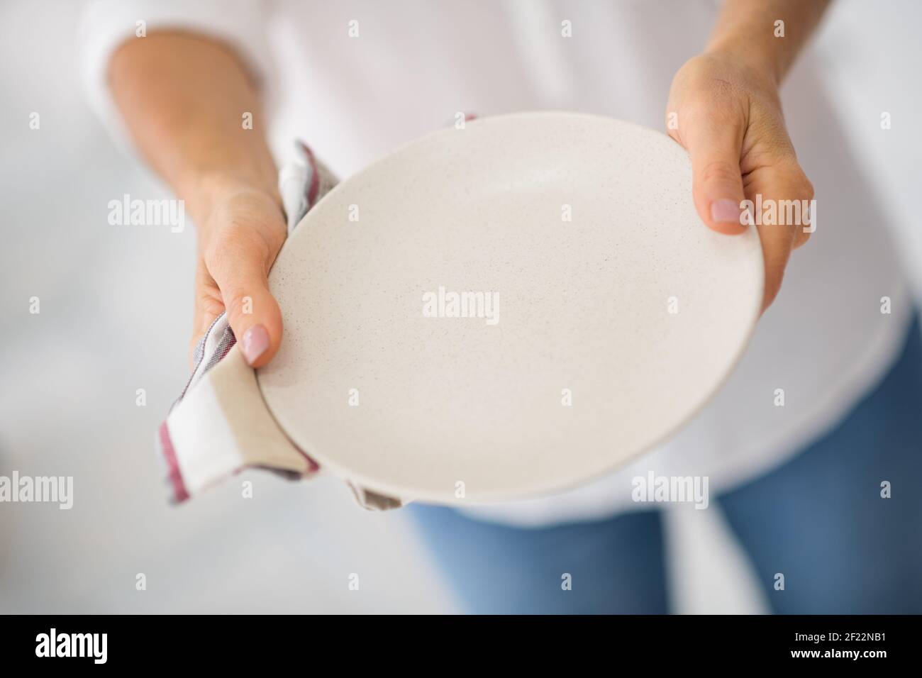 Close up picture of a woman with plate in hands Stock Photo