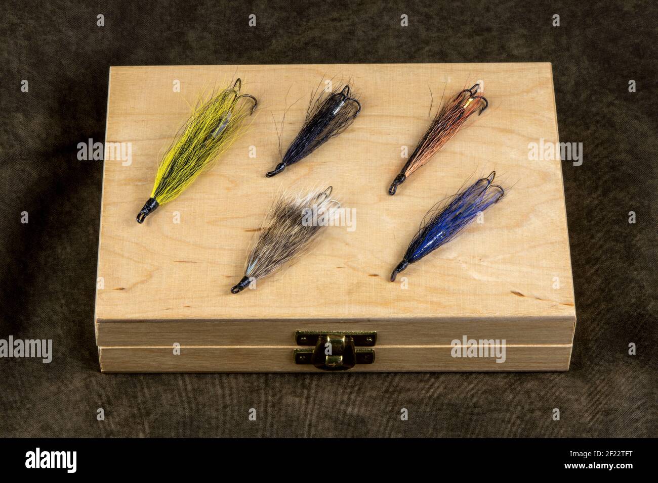 Traditional wooden fly box with salmon flies on an outdoor coat Stock Photo  - Alamy