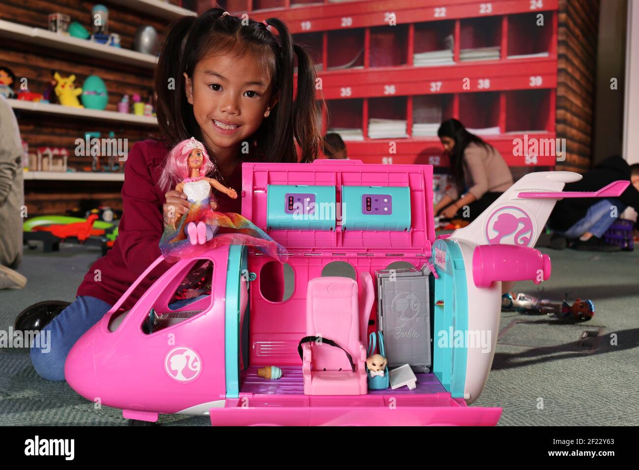 6-year-old Trilyna plays with the Barbie Dreamplane playset, one of the Top 12 toys this Christmas unveiled at Dreamtoys 2019 in London. The list, issued by the Toy Retailers Association predicts what will be hot this Christmas. It is selected by a panel of retailers and industry experts and is fiercely independent of toy manufacturers and makers. Photo credit should read: Katie Collins/EMPICS Entertainment/Alamy Stock Photo