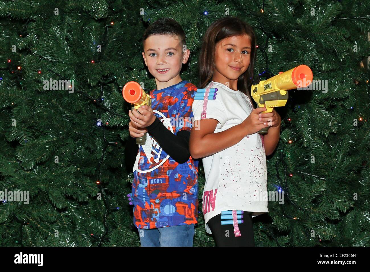 Joshua (8) and Ayva (7) each hold the the Nerf Elite Fortnite SP-L, one of the Top 12 toys this Christmas unveiled at Dreamtoys 2019 in London. The list, issued by the Toy Retailers Association predicts what will be hot this Christmas. It is selected by a panel of retailers and industry experts and is fiercely independent of toy manufacturers and makers. Photo credit should read: Katie Collins/EMPICS Entertainment/Alamy Stock Photo