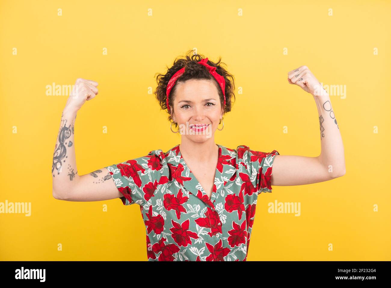 Valladolid, Spain: March 1, 2021: A woman shows her strength with her arms in a feminist gesture Stock Photo