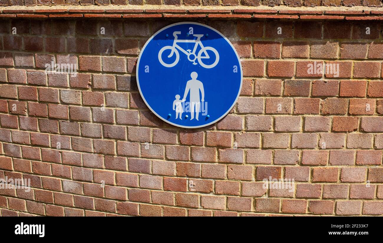 Blue circular road sign indication pedestrians and cyclists to share a