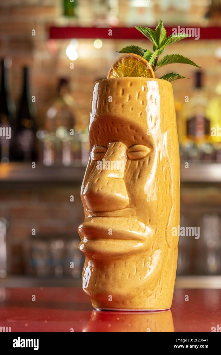 Refreshing cold Tiki cocktail on the bar. Summer party background. Stock Photo