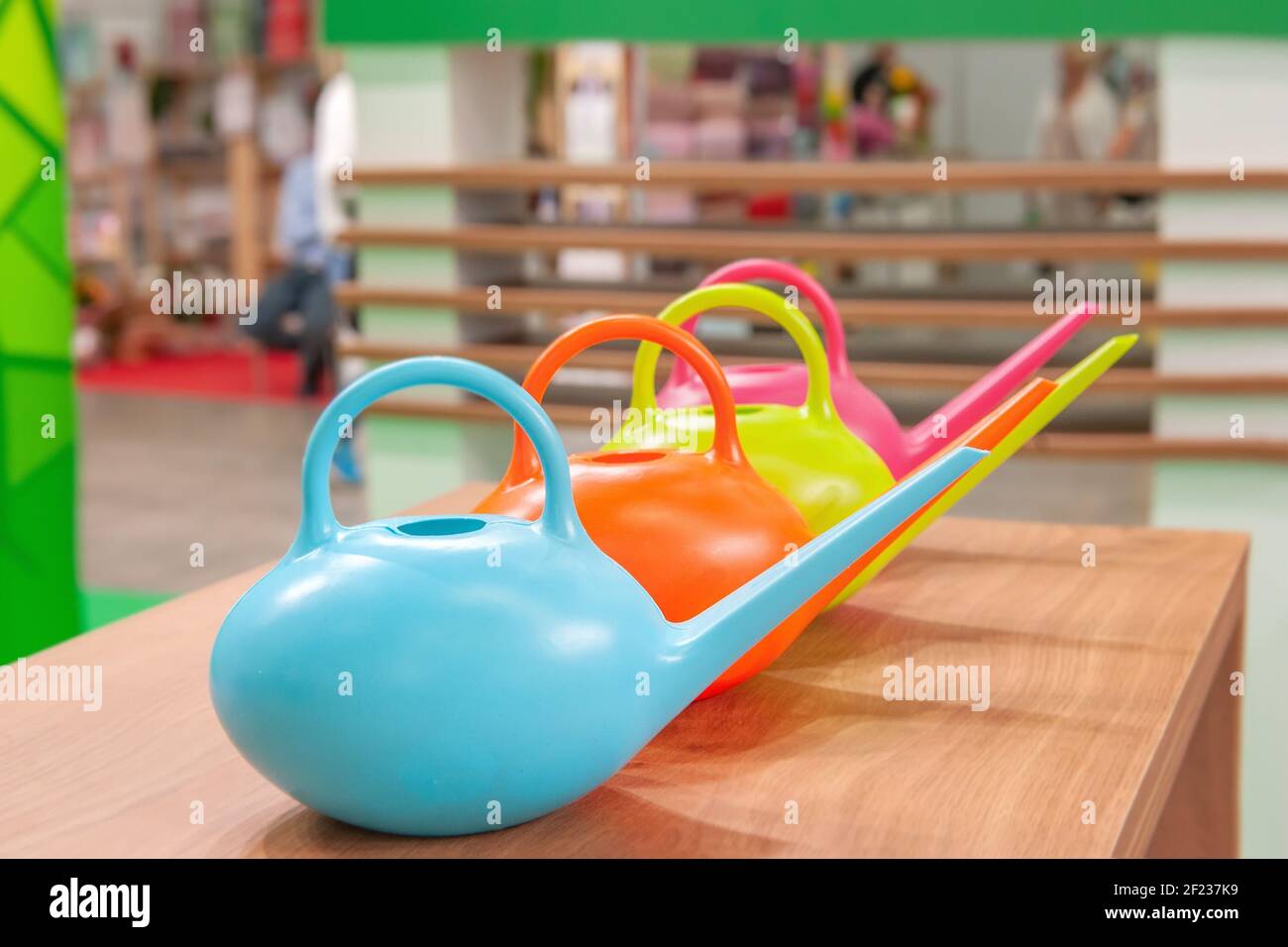 Garden watering cans for sale in a hardware store on a retail shelf. concept of care for indoor and garden plants. Stock Photo