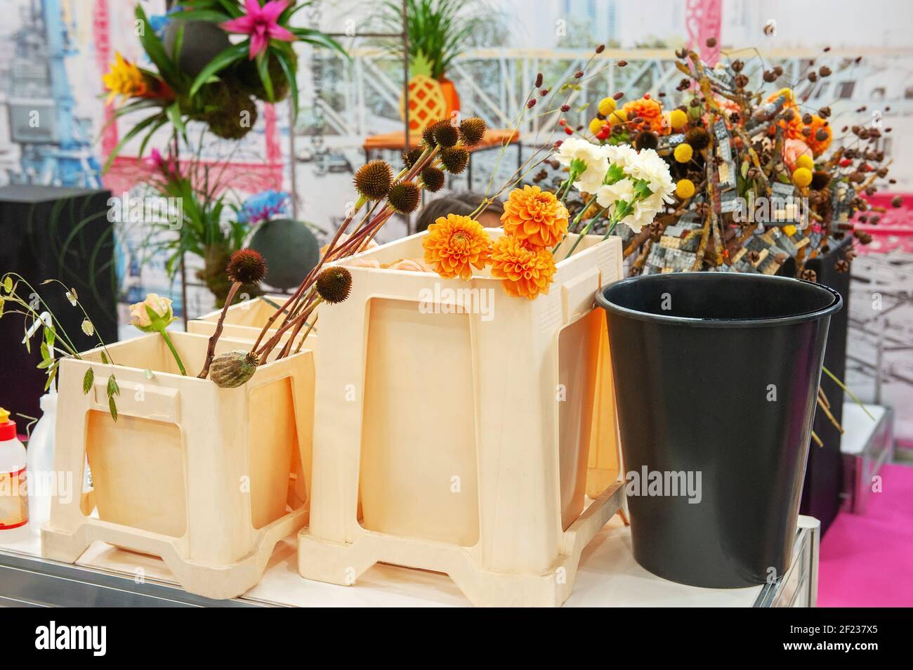 On the shelves of the store, tall plastic vases, containers of various