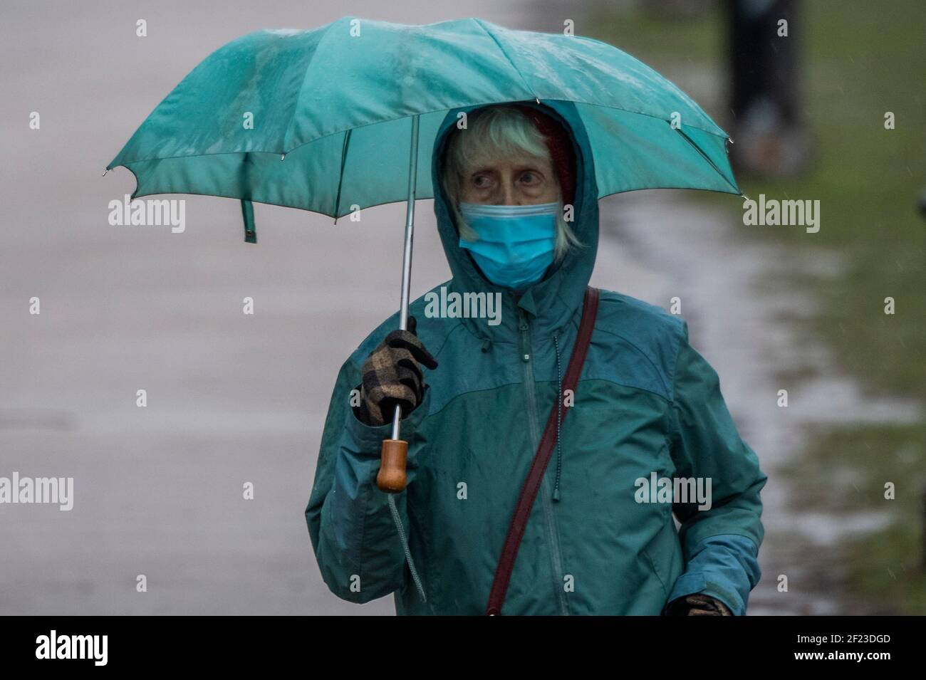 London, UK. 10th Mar, 2021. It is raining and cold but people are still out meeting friends and/or getting some exercise. Outdoor life on Clapham Common towards the end of Lockdown 3. Credit: Guy Bell/Alamy Live News Stock Photo