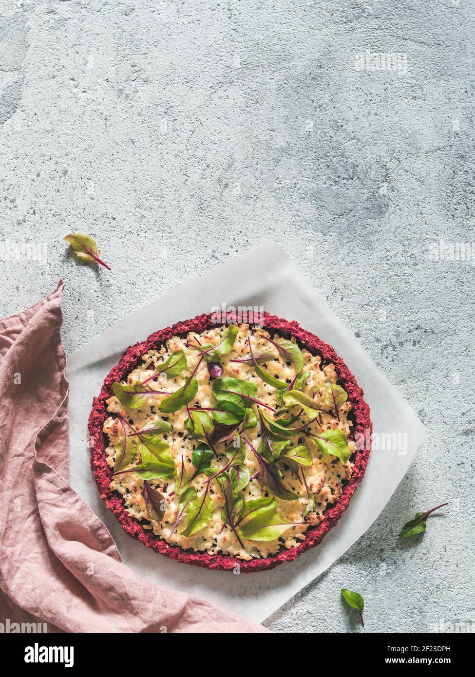 Beetroot pizza crust with fresh mangold leaves Stock Photo
