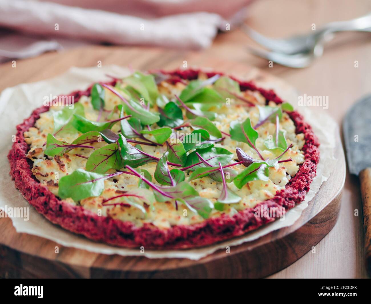 Beetroot pizza crust with fresh mangold leaves Stock Photo
