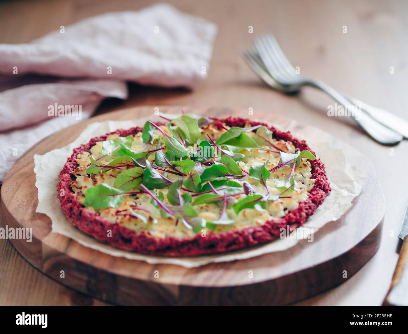 Beetroot pizza crust with fresh mangold leaves Stock Photo