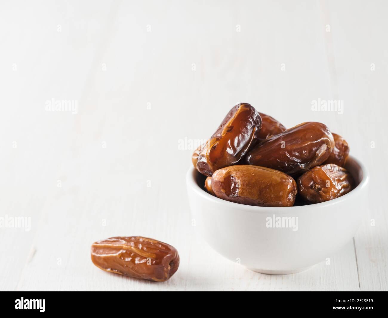 Plate of dried dates on table Stock Photo