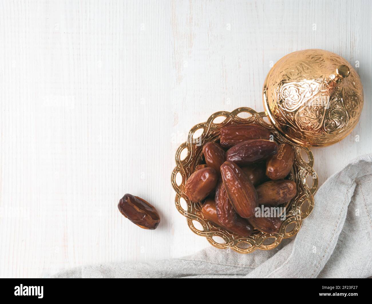 Plate of dried dates on gray Stock Photo