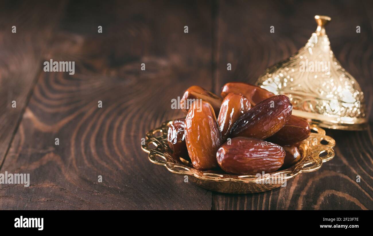 Plate of pitted dates on table Stock Photo