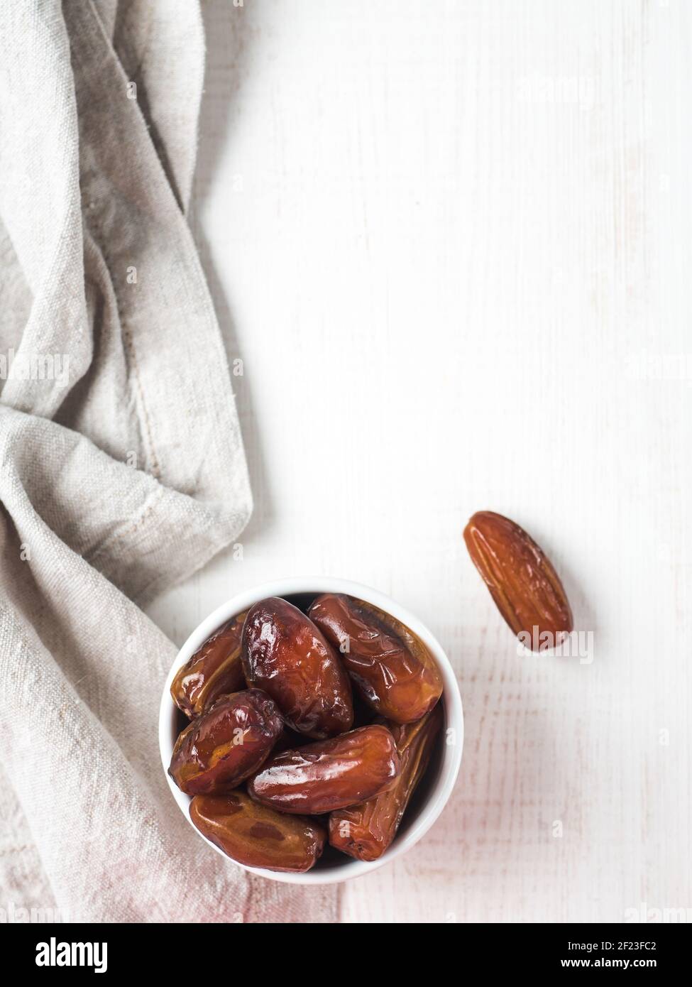 Plate of dried dates on table Stock Photo
