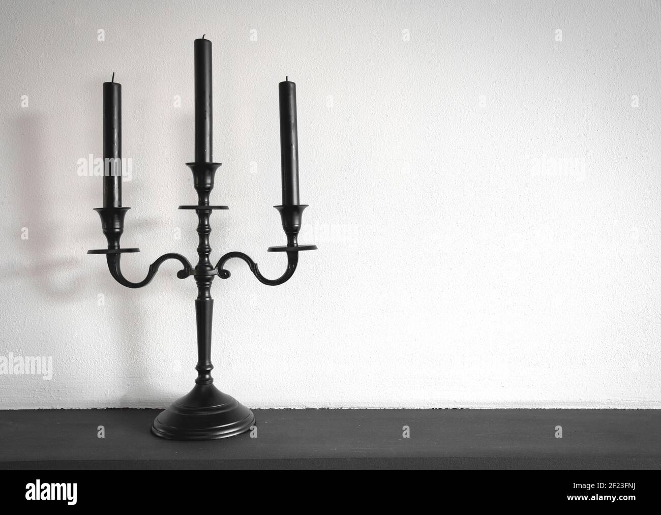 Old vintage retro black candle holder near white background, copy space