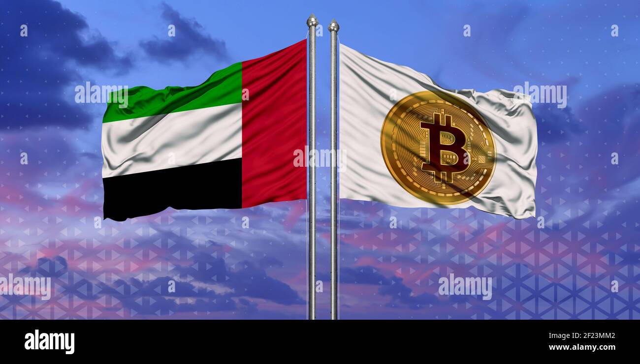 The UAE and Bitcoin flags are waving over the blue sky Stock Photo