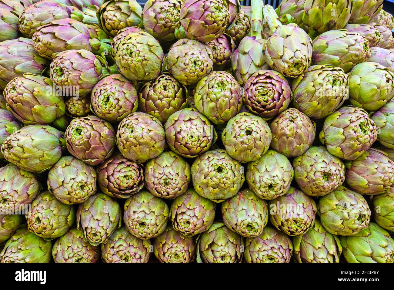 Pile of artichokes for sale at a market Stock Photo