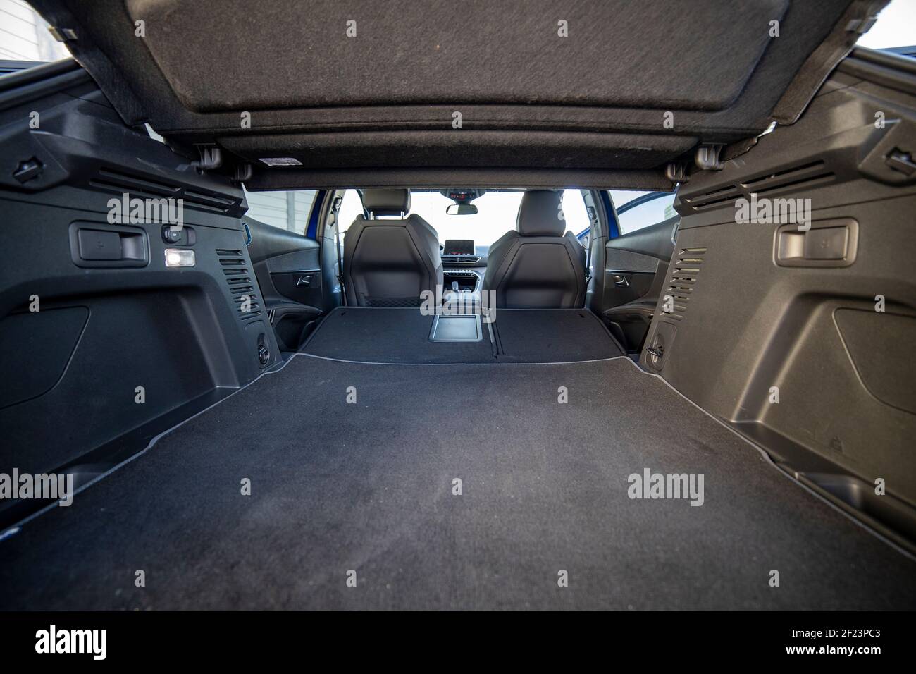 empty trunk of a modern car with folded rear seats. large interior volume. trunk view. Stock Photo