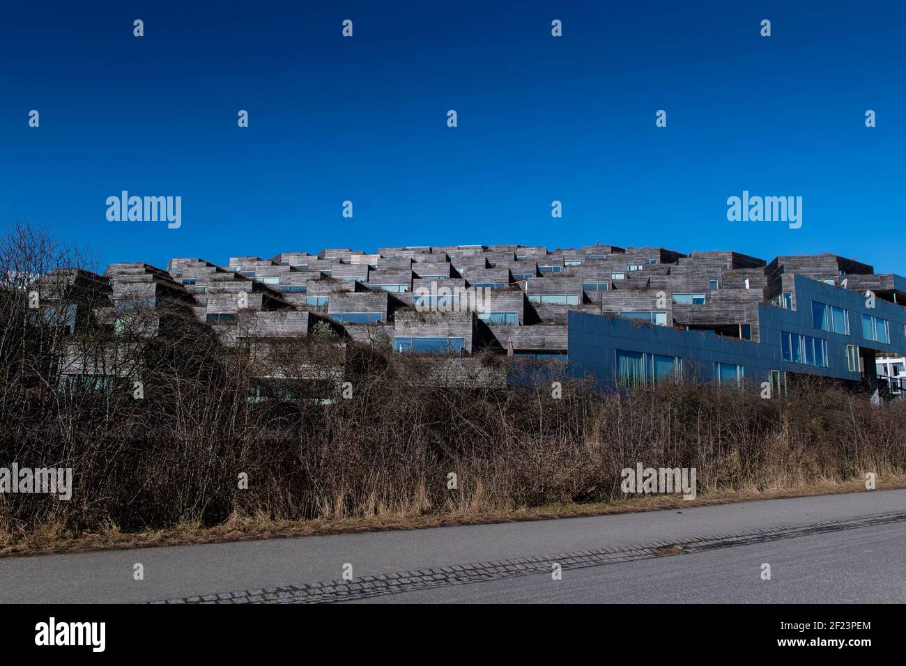 Mountain Dwellings (Danish: Bjerget) is a building in the Ørestad district of Copenhagen, Denmark, consisting of apartments above a multi-story car pa Stock Photo