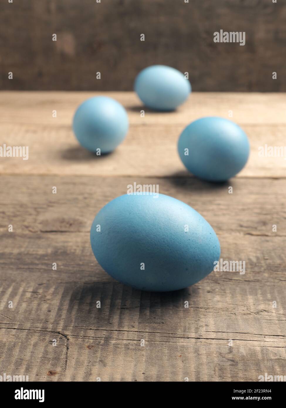 Naturally colored organic eggs on a rustic table with space for text, Easter background Stock Photo