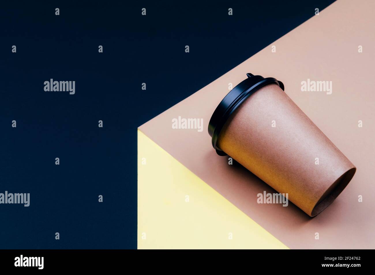 Disposable cardboard cup on a platform with space for text. Stock Photo