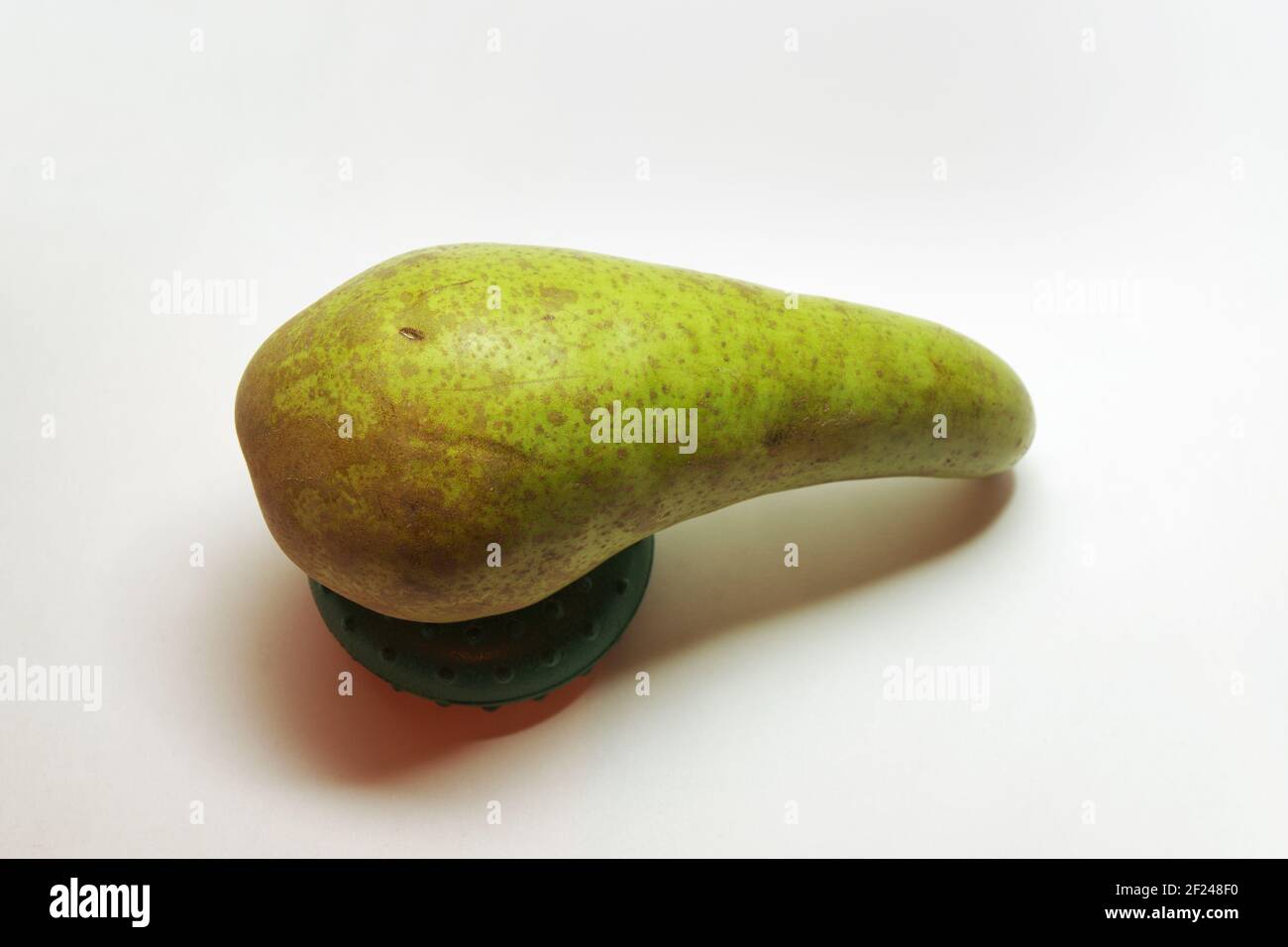 pear conference, elegantly curved, half green, with gray-brown spots ...