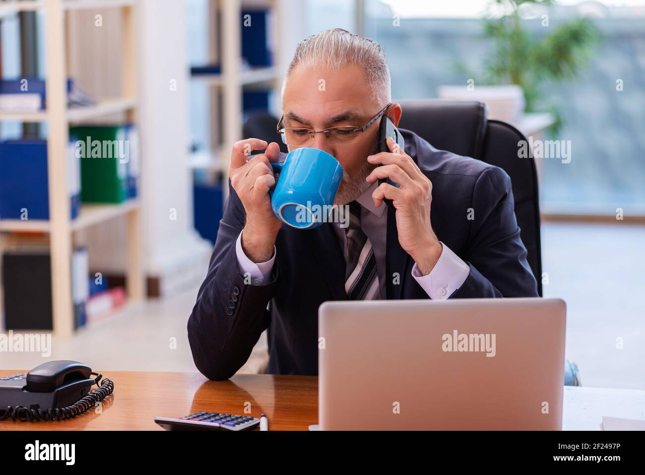 Old businessman employee having hi-res stock photography and images - Alamy