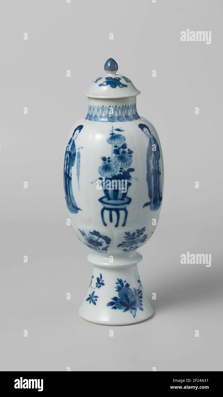 Ovoid covered vase with Chinese ladies, flower sprays and vases.Lid of egg-shaped porcelain lid pot, painted in underglaze blue. On the lid valuables (diamond, pearl, artimisialablad) between which three Chinese characters 'Zhou', prosperity meaning and a blue button. Blue White. Stock Photo