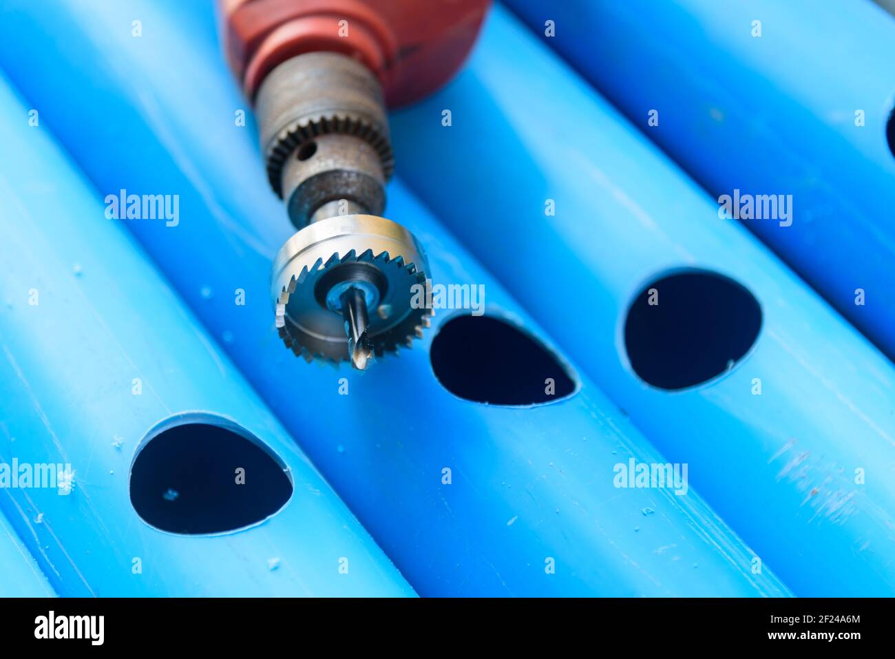 The man use HOLE SAW Perforate the PVC pipe hole Stock Photo Alamy