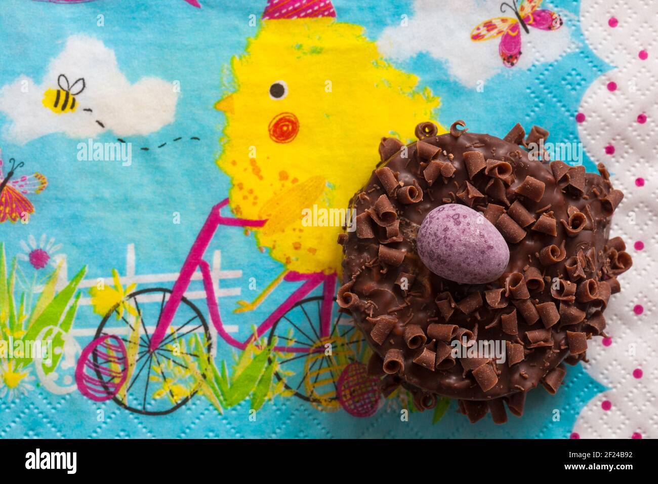 Cadbury Mini Eggs Nest Cake set on Easter serviette napkin Stock Photo