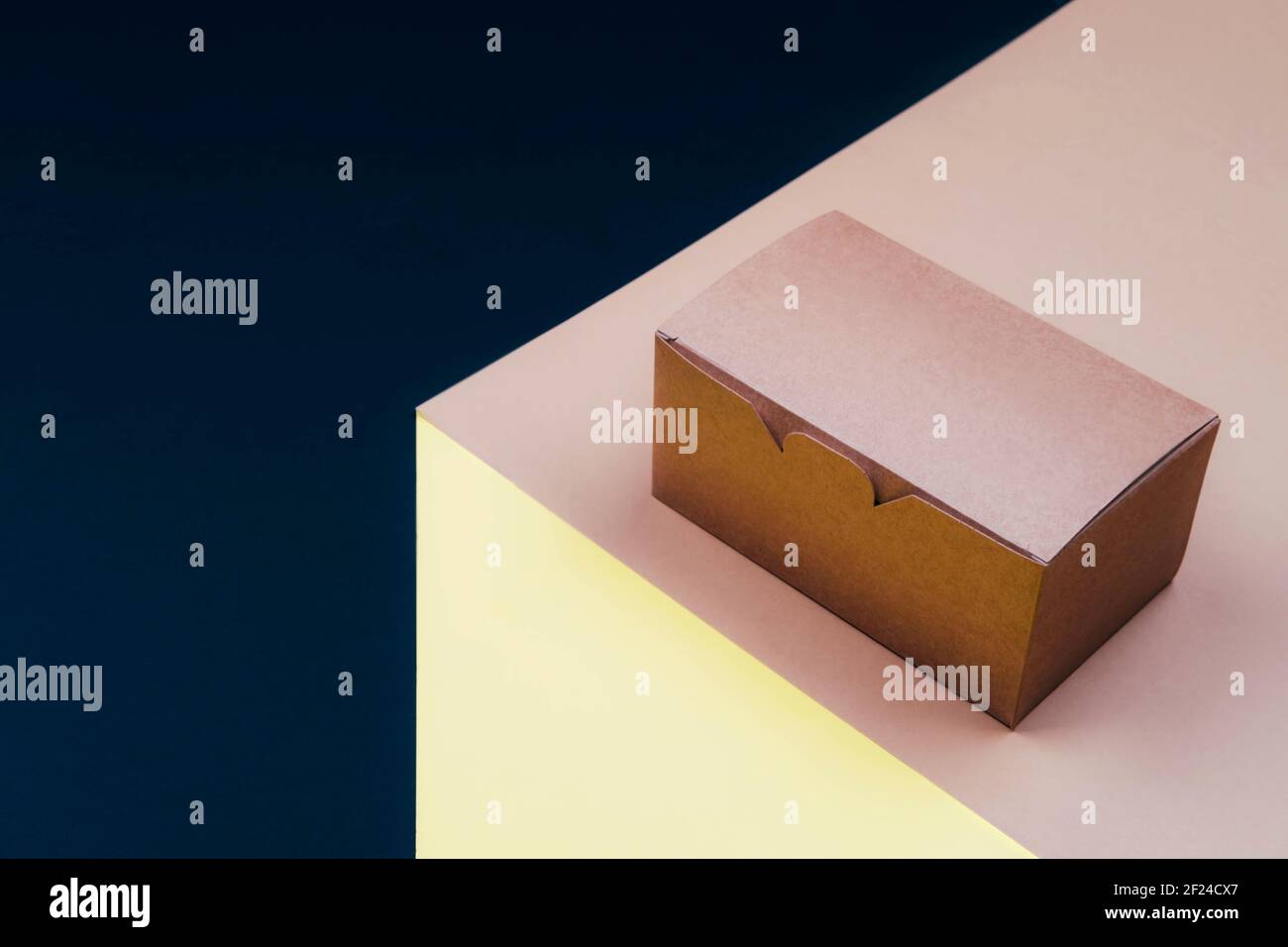 Disposable cardboard container on a platform with space for text. Stock Photo