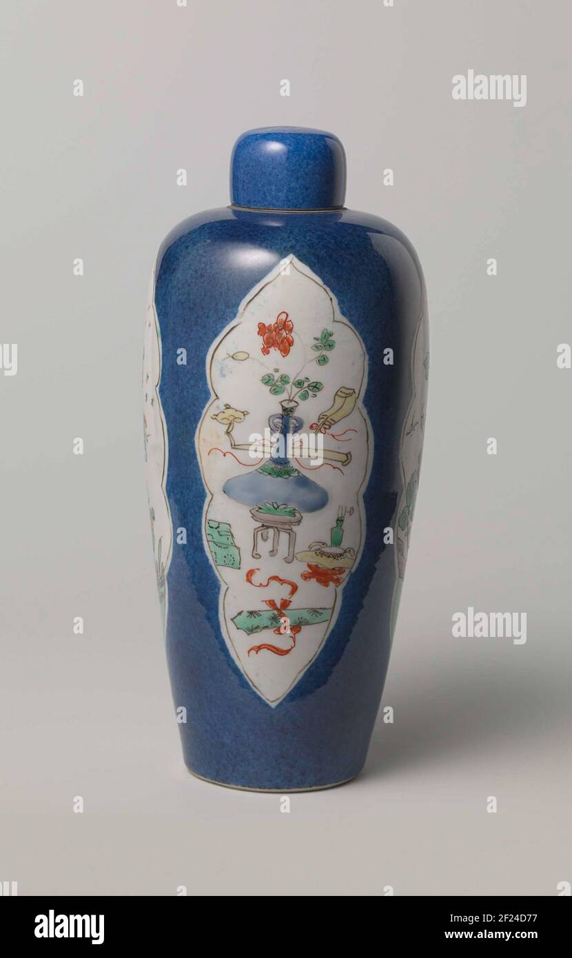 Covered vase with bleu poudré, flower sprays and antiquities.Porcelain vase lid, painted in underglaze blue and on the glaze blue, red, green, yellow eggplant, black and gold. Covered with powder blue. Bleu poudré with famille verte. Stock Photo