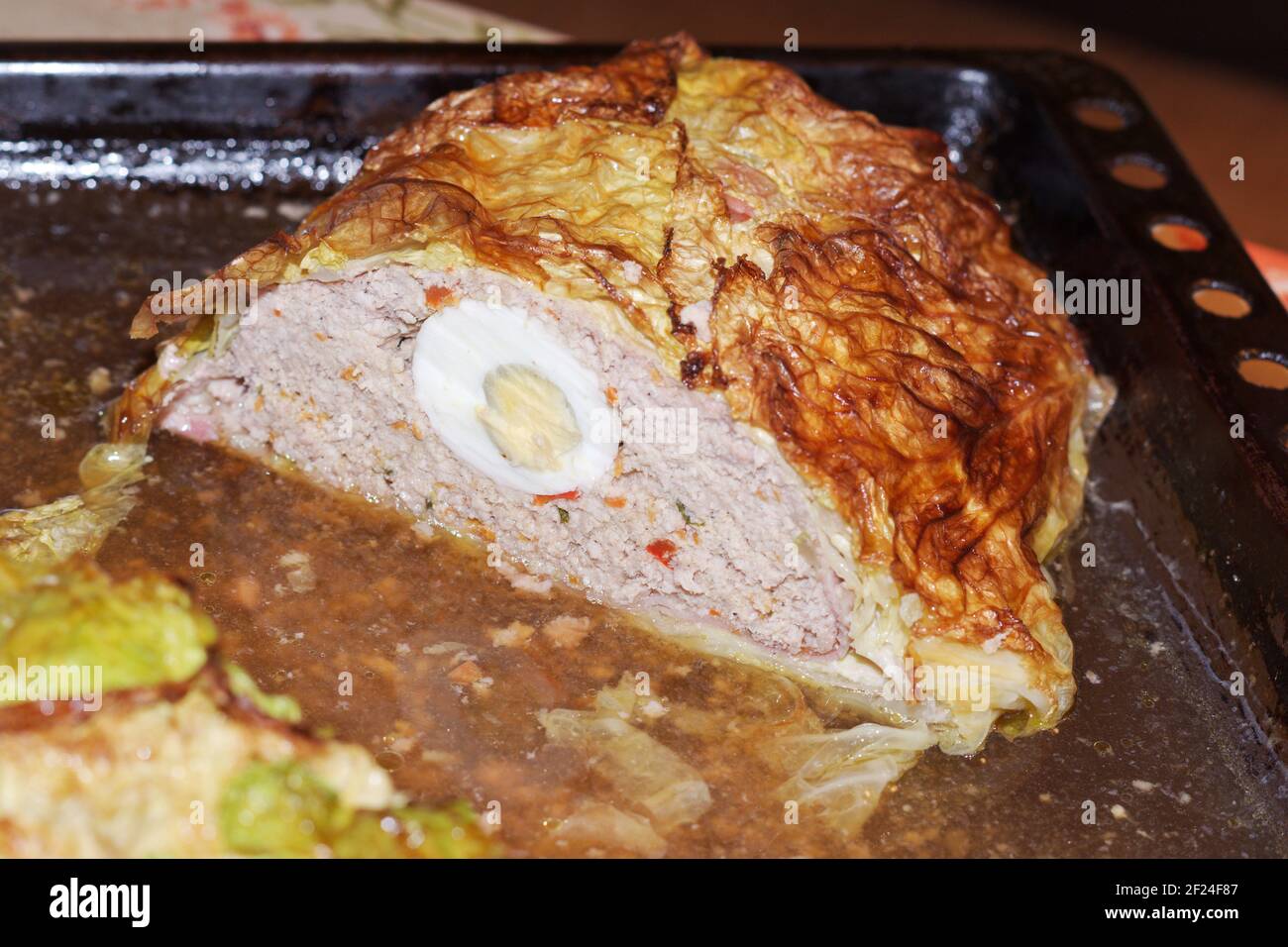 homemade meatloaf with eggs in Savoy cabbage leaves. last half, on