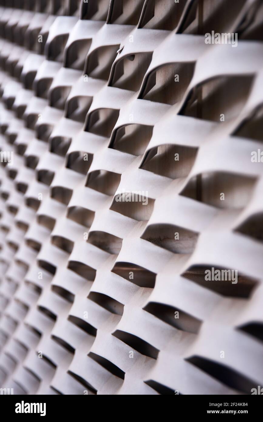 Abstract decoration in white metal on urban wall. Stock Photo