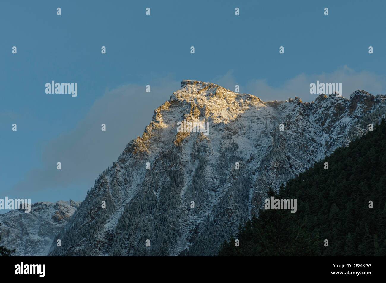 Snowy peak with evening light Stock Photo - Alamy