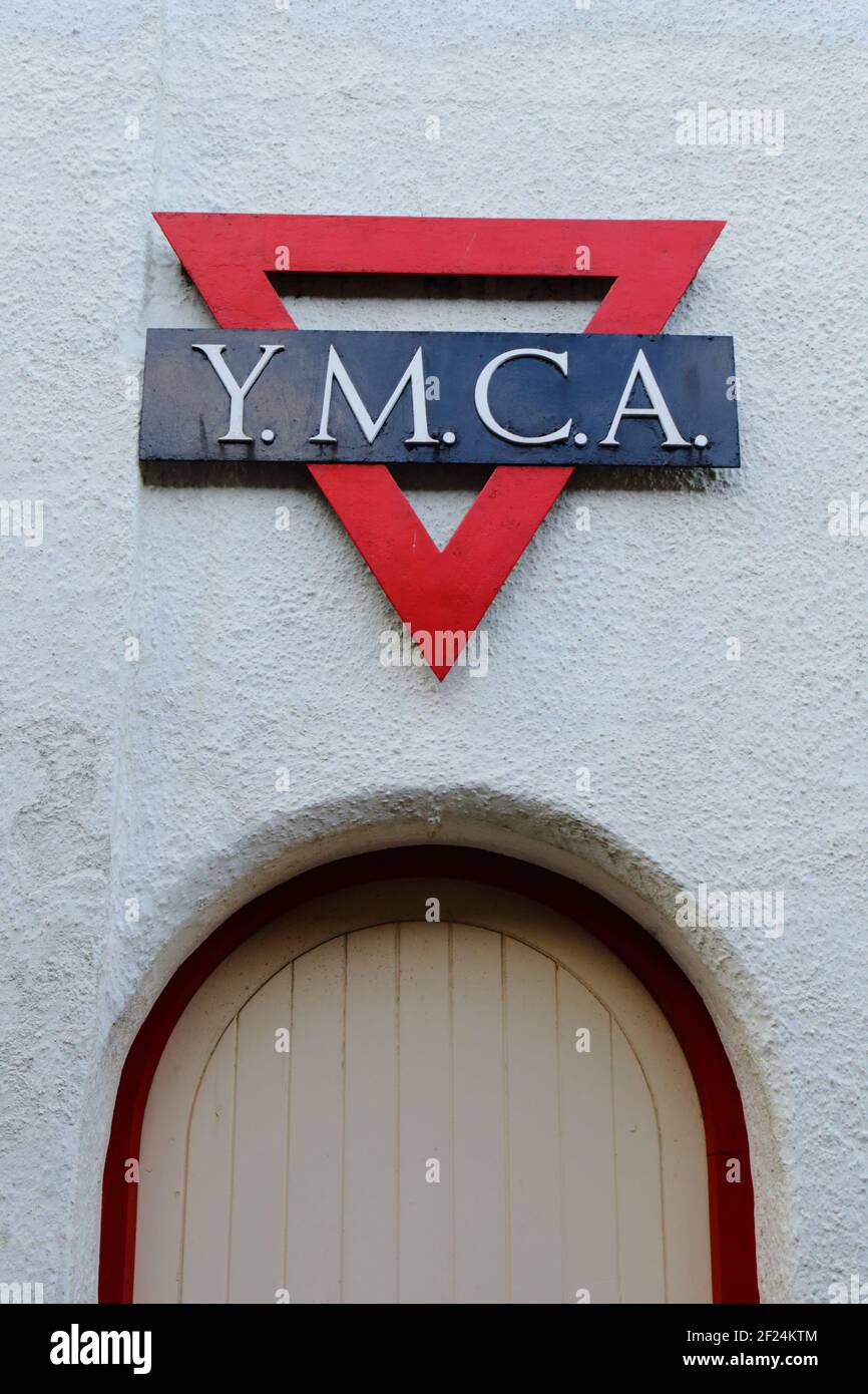 YMCA (Young Men's Christian Association) sign on the white wall in town of Sidmouth, Devon Stock Photo