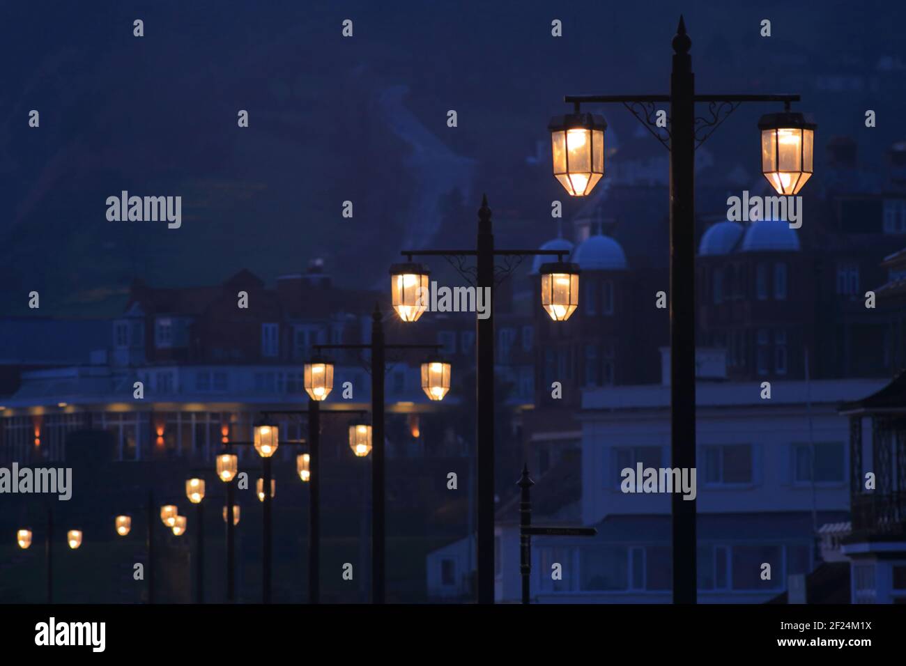 Row of street lights at sunset  in town of Sidmouth, Devon Stock Photo