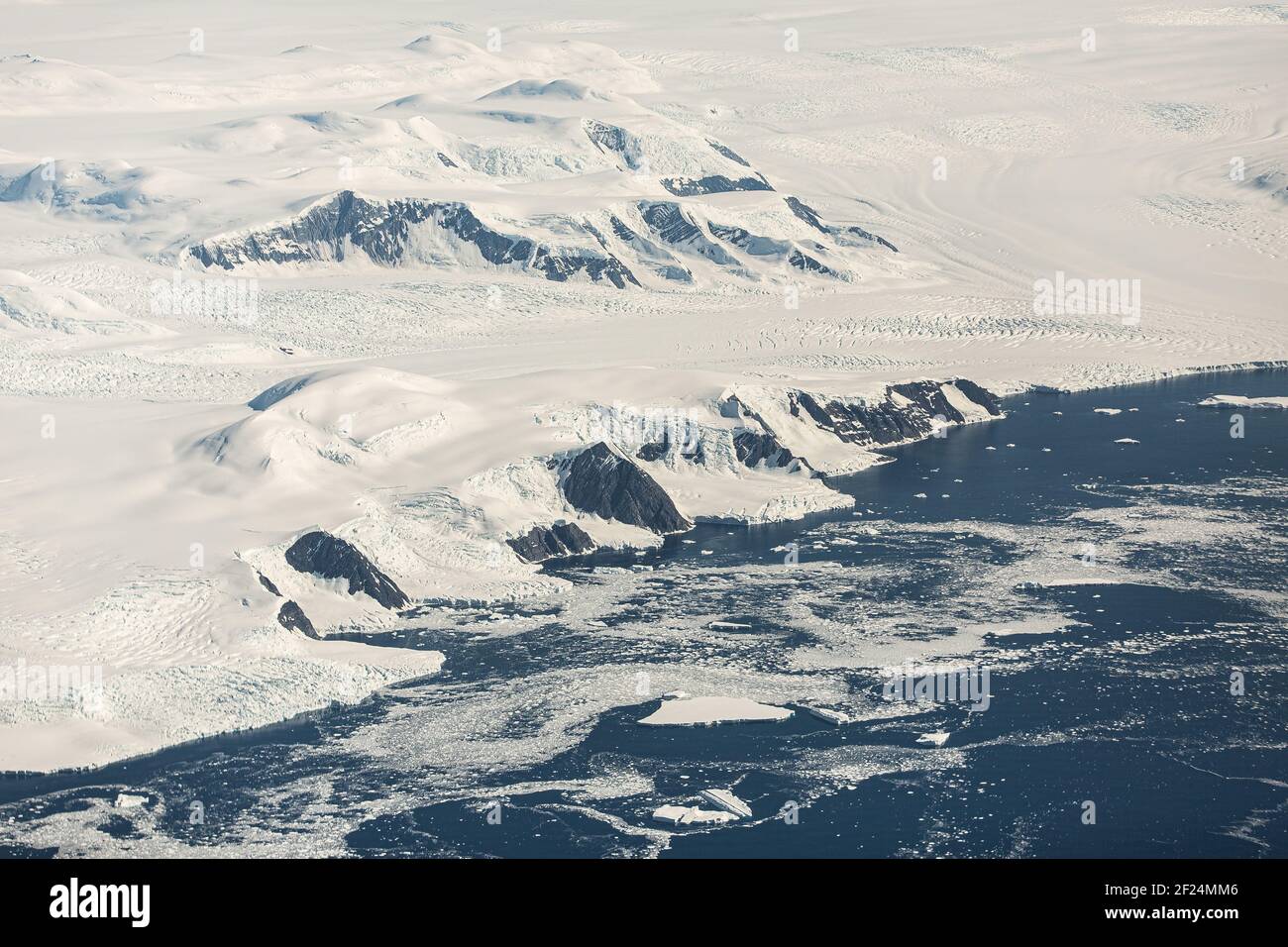 An aerial view of the snowy ice-covered landmass in Antarctica Stock Photo
