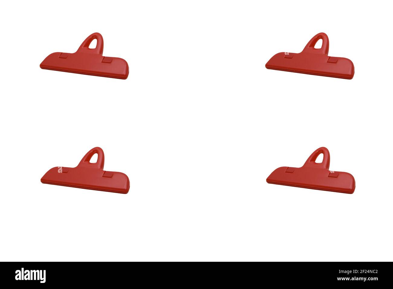 Red plastic clips (paper clips) for a paper separately on a white