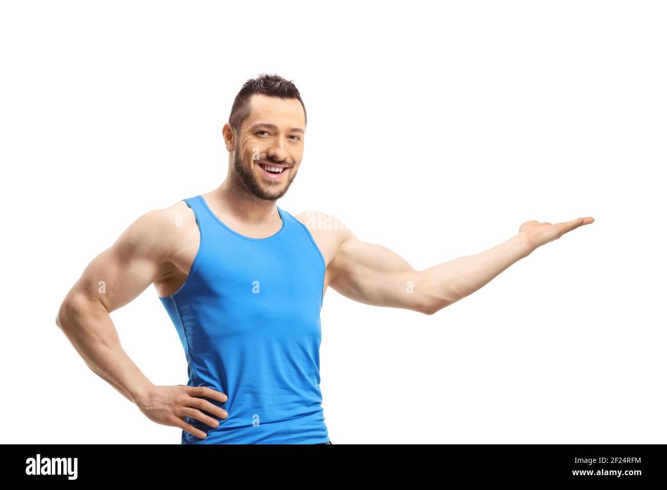 Full length portrait of a young muscular man in sportswear showing with ...