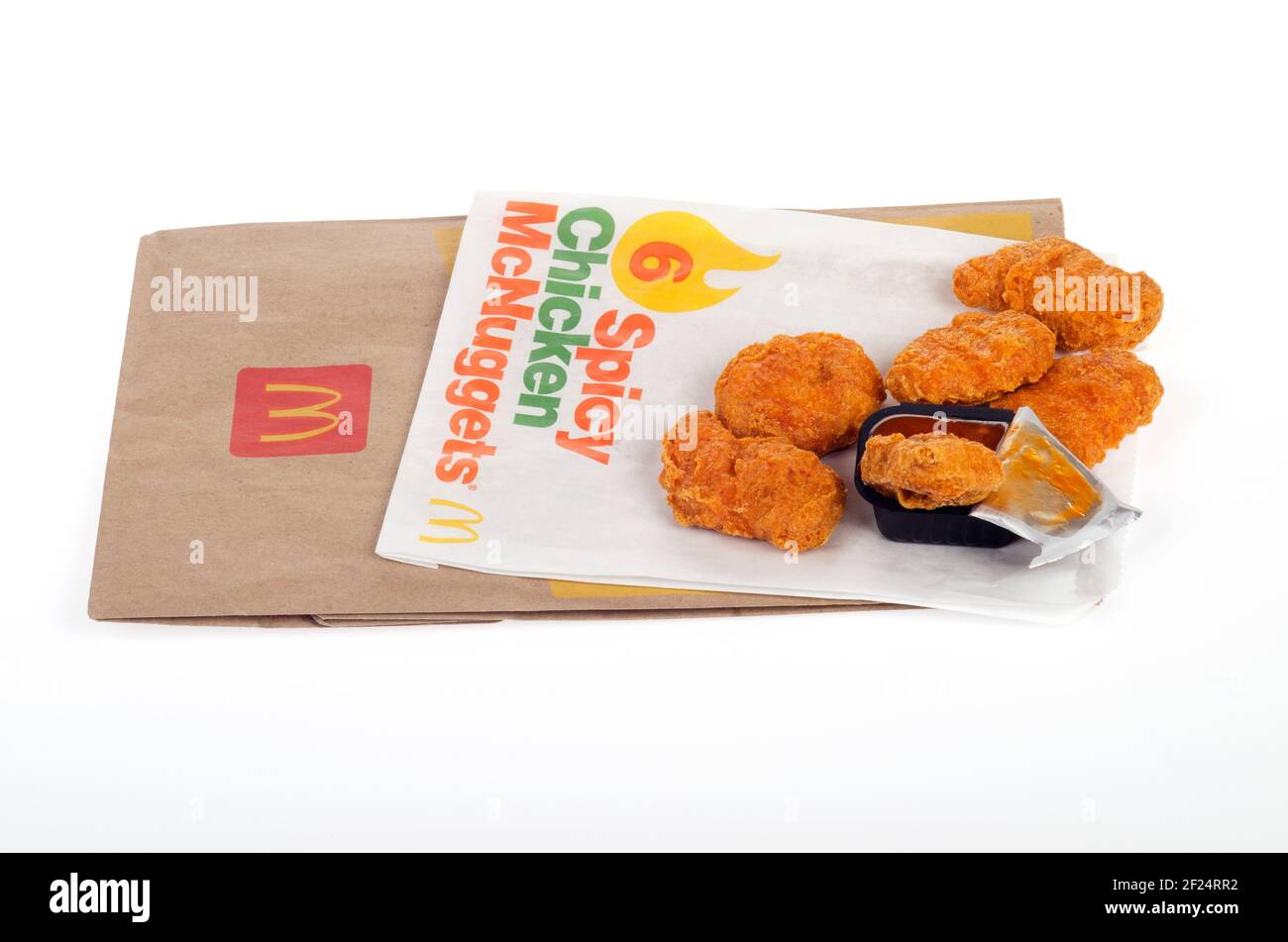 McDonald's Spicy Chicken McNuggets with Hot Dipping Sauce on wrapper with bag Stock Photo