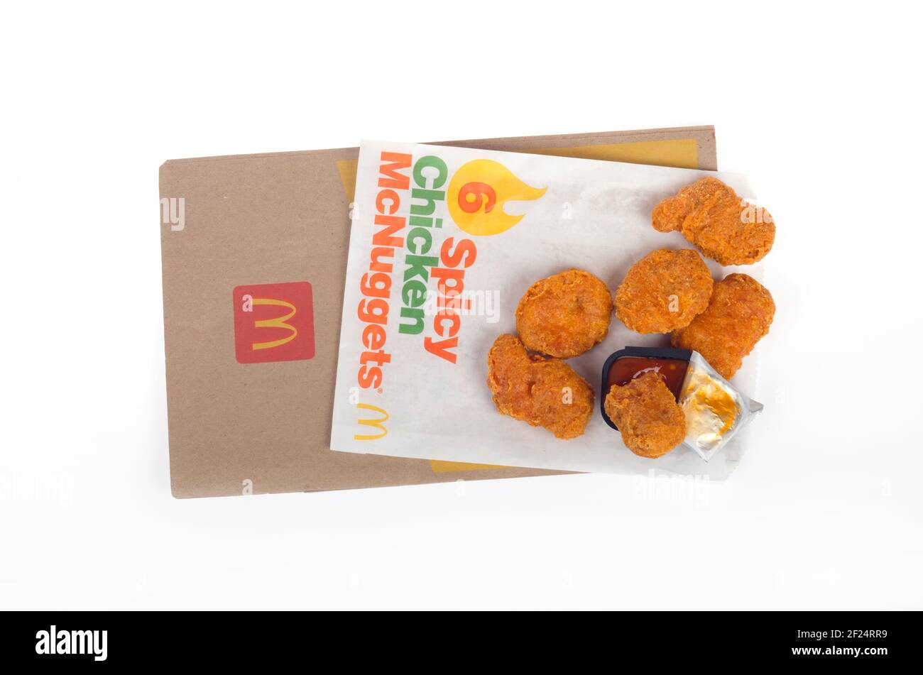 McDonald's Spicy Chicken McNuggets with Hot Dipping Sauce on wrapper with bag Stock Photo