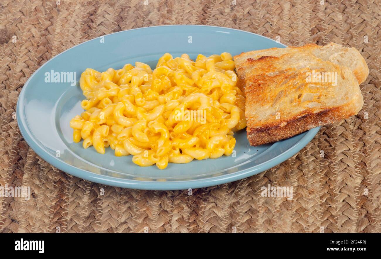 Plate of Vegan Macaroni & Cheese with Sourdough bread Stock Photo