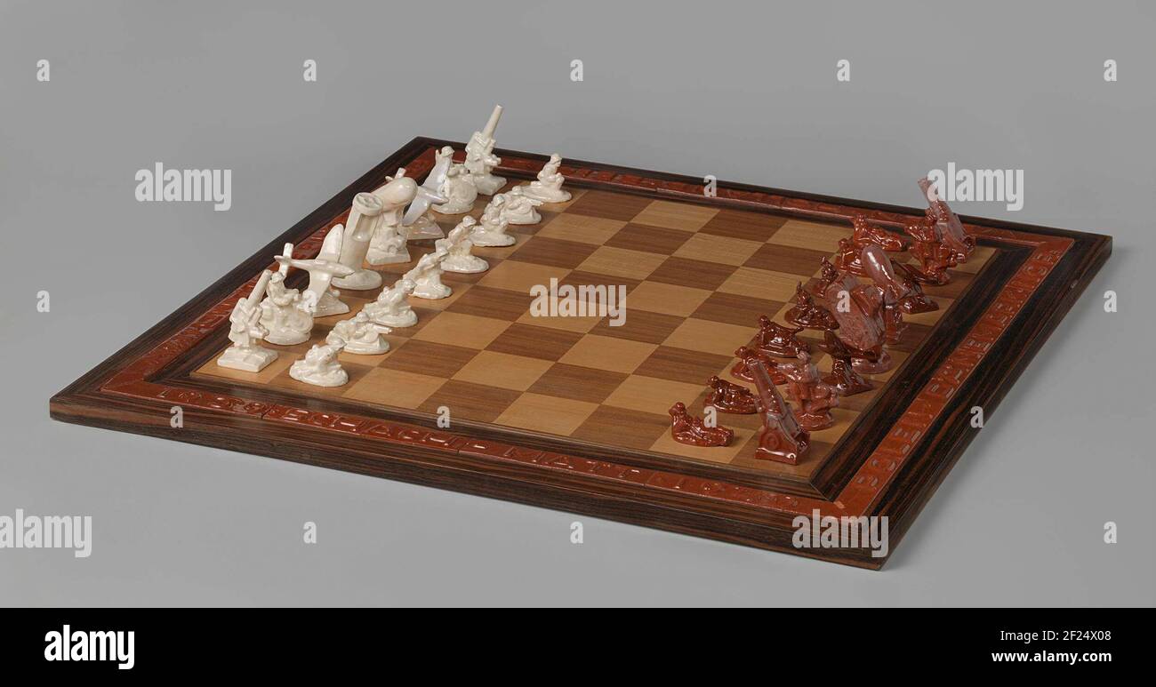 Nazi chess set.This chess set glorifies Nazi Germany’s territorial ambitions during World War II. The pieces are shaped like weapons. The text in the border lists the countries that Germany had attacked in 1939 and 1940. This set may have been presented in 1941 by SS Commander Heinrich Himmler to Anton Mussert, leader of the Nationaalsocialistische Beweging (NSB), the National Socialist Movement in the Netherlands. Stock Photo